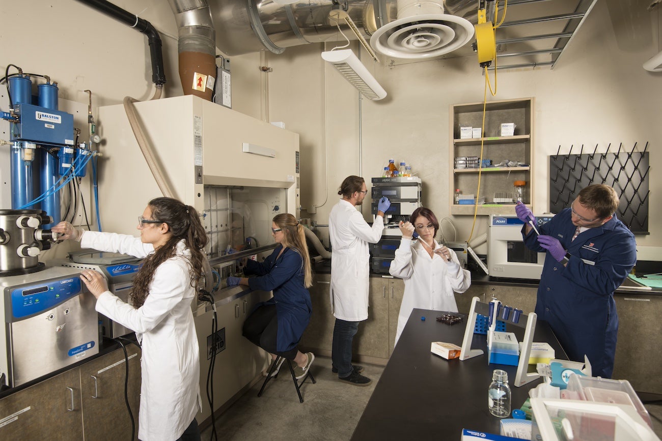 Persons work in a science lab