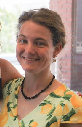 Woman with a flower print shirt and brown hair.