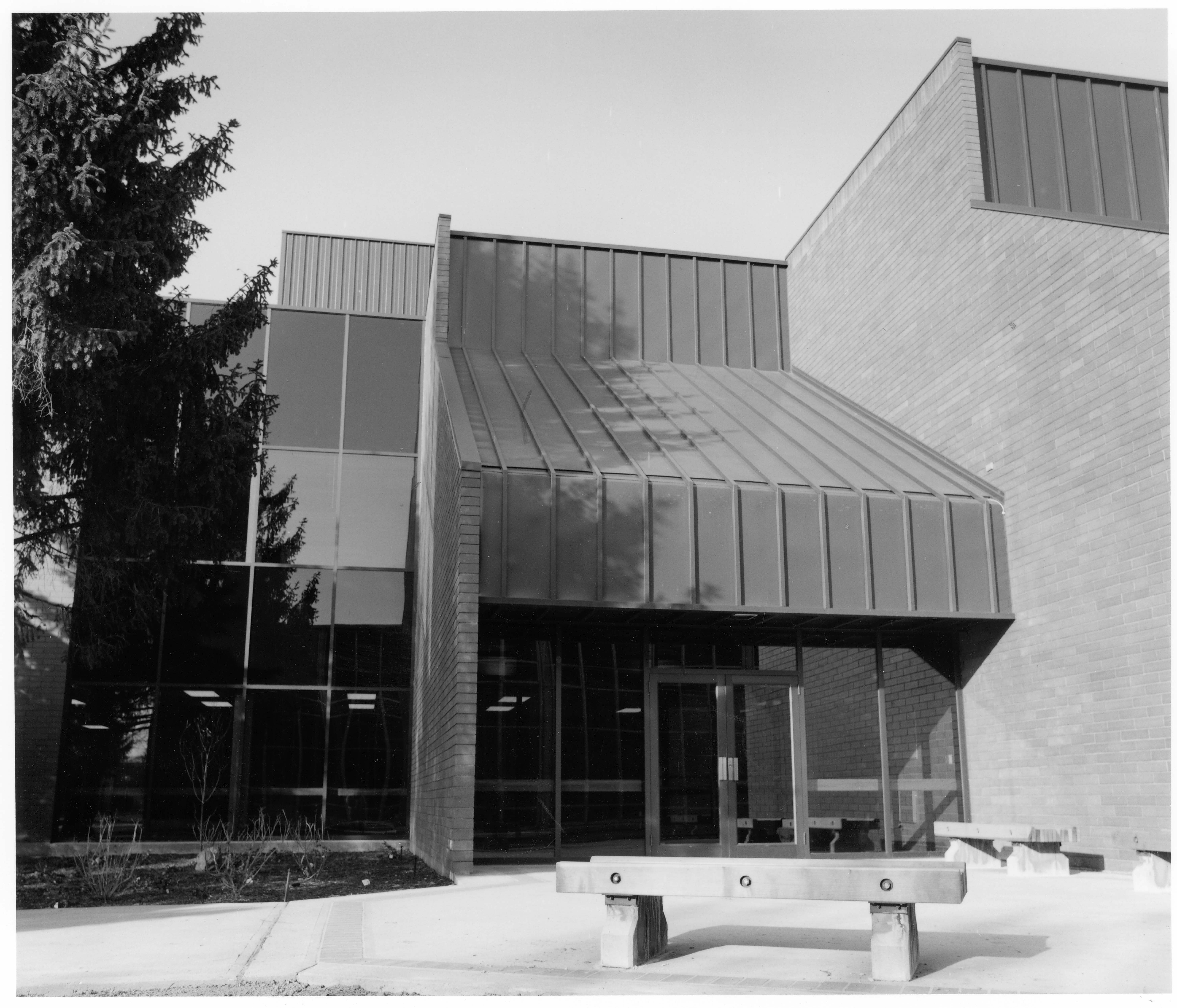 Black and white photo of SMASH building with sloped roof and entrance doors.