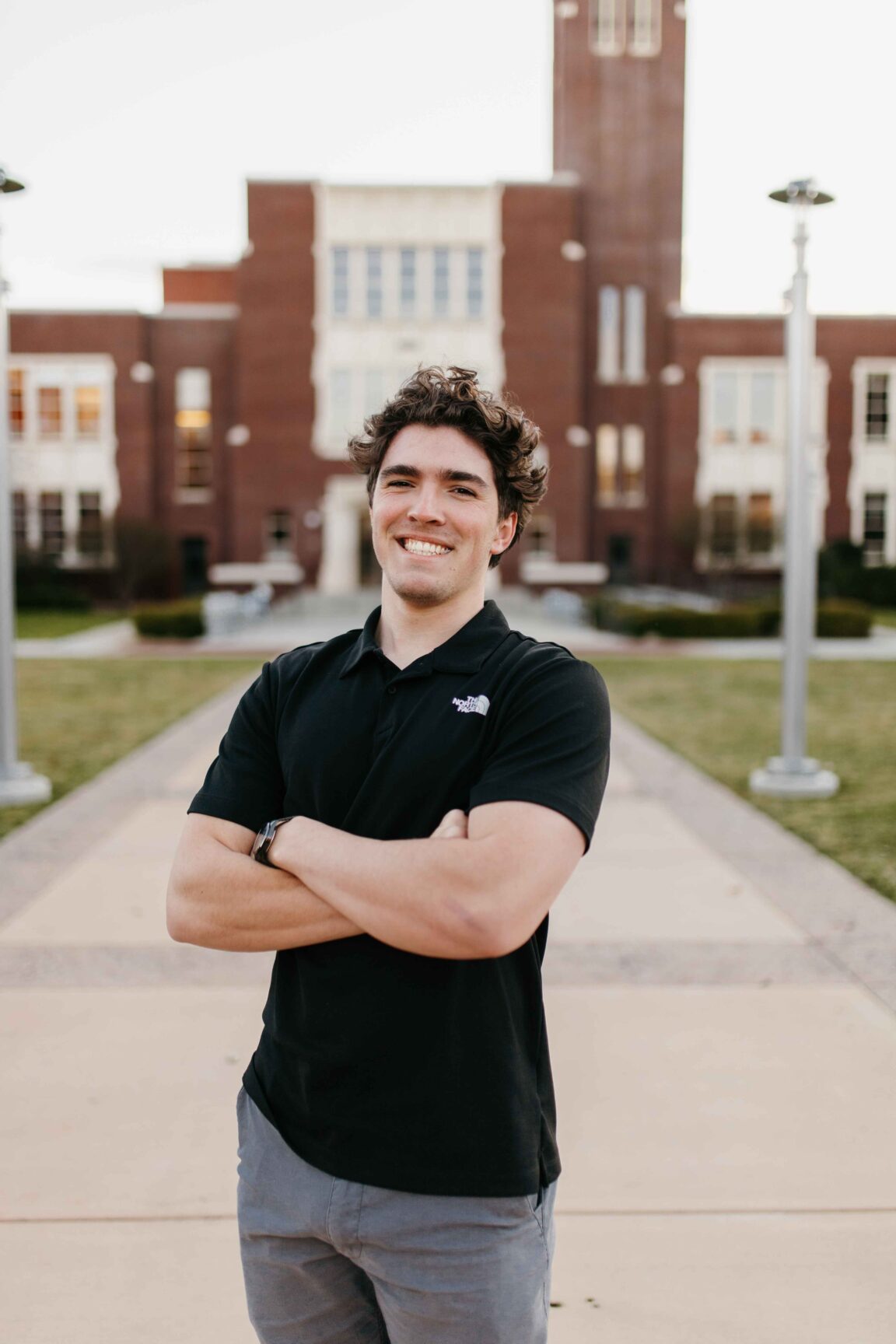 Joe Amorebieta stands in front of a brick building smiling