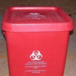 photo shows a properly secured waste container with lid fully clasped down