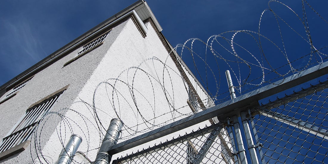 view of razor wire in front of a prison building