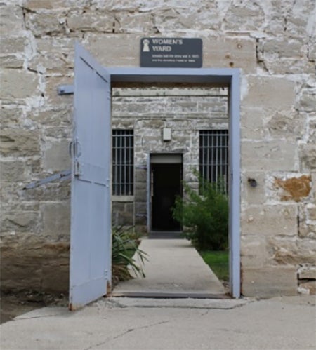 Prison door with sign reading women's ward