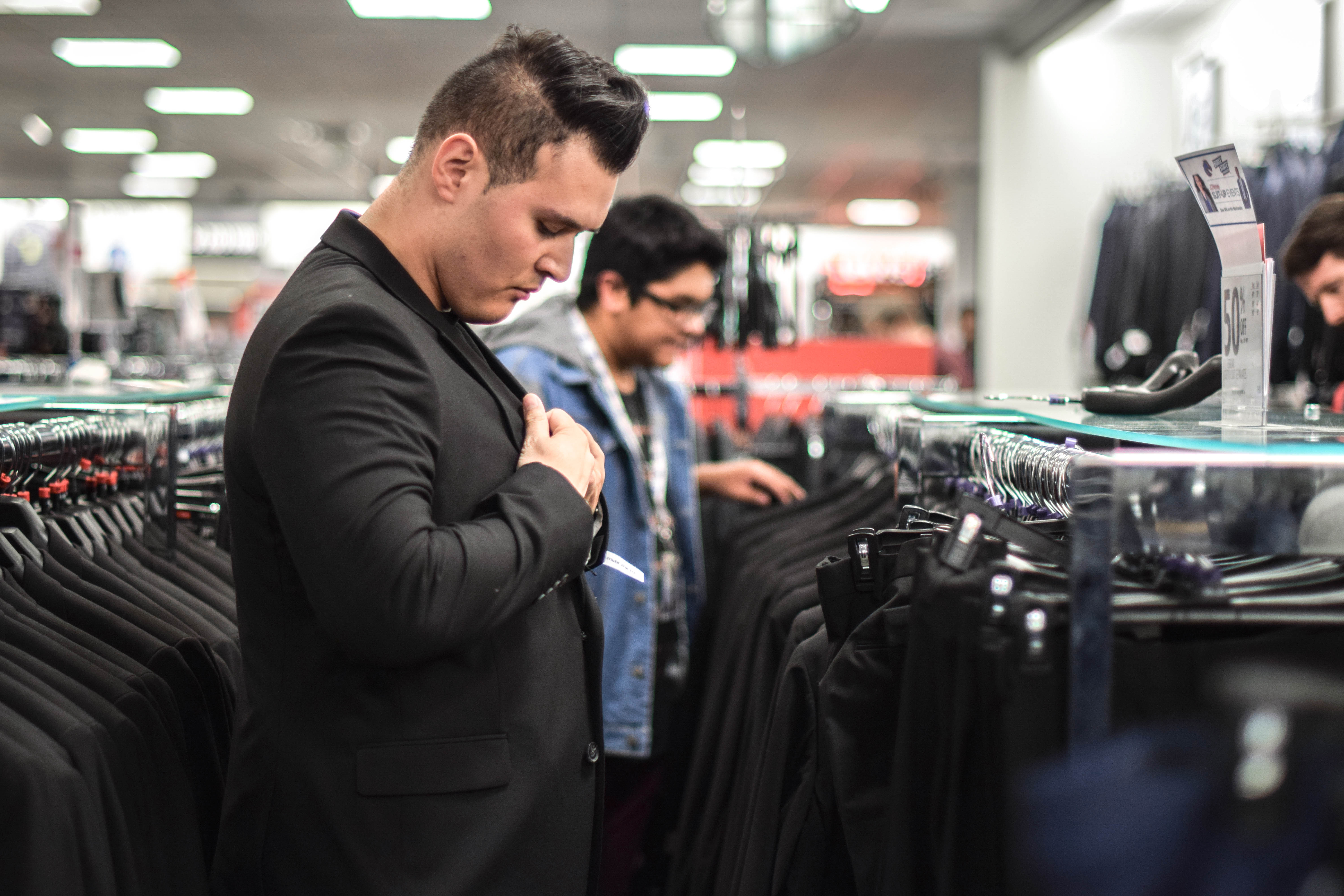 Student trying on clothes at suit up event