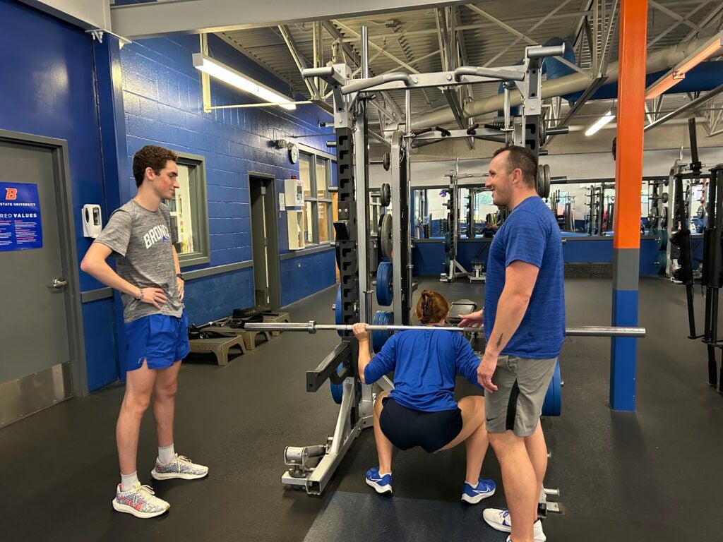 Student athlete learning demonstrating proper lifting technique