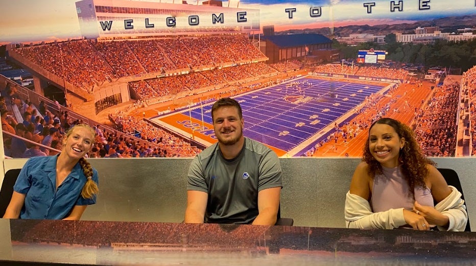 football intern at a desk smiling