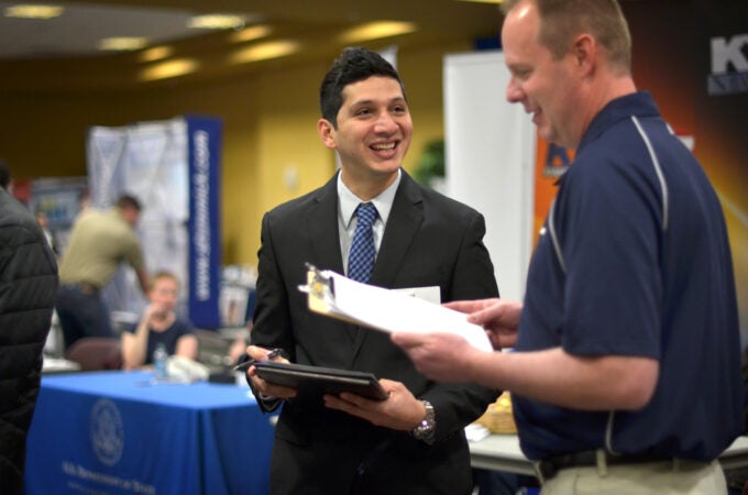 Student networking with an employer at the Career Fair