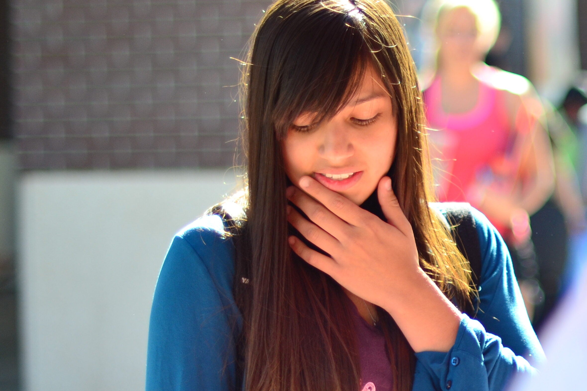 Student with hand on face contemplating something