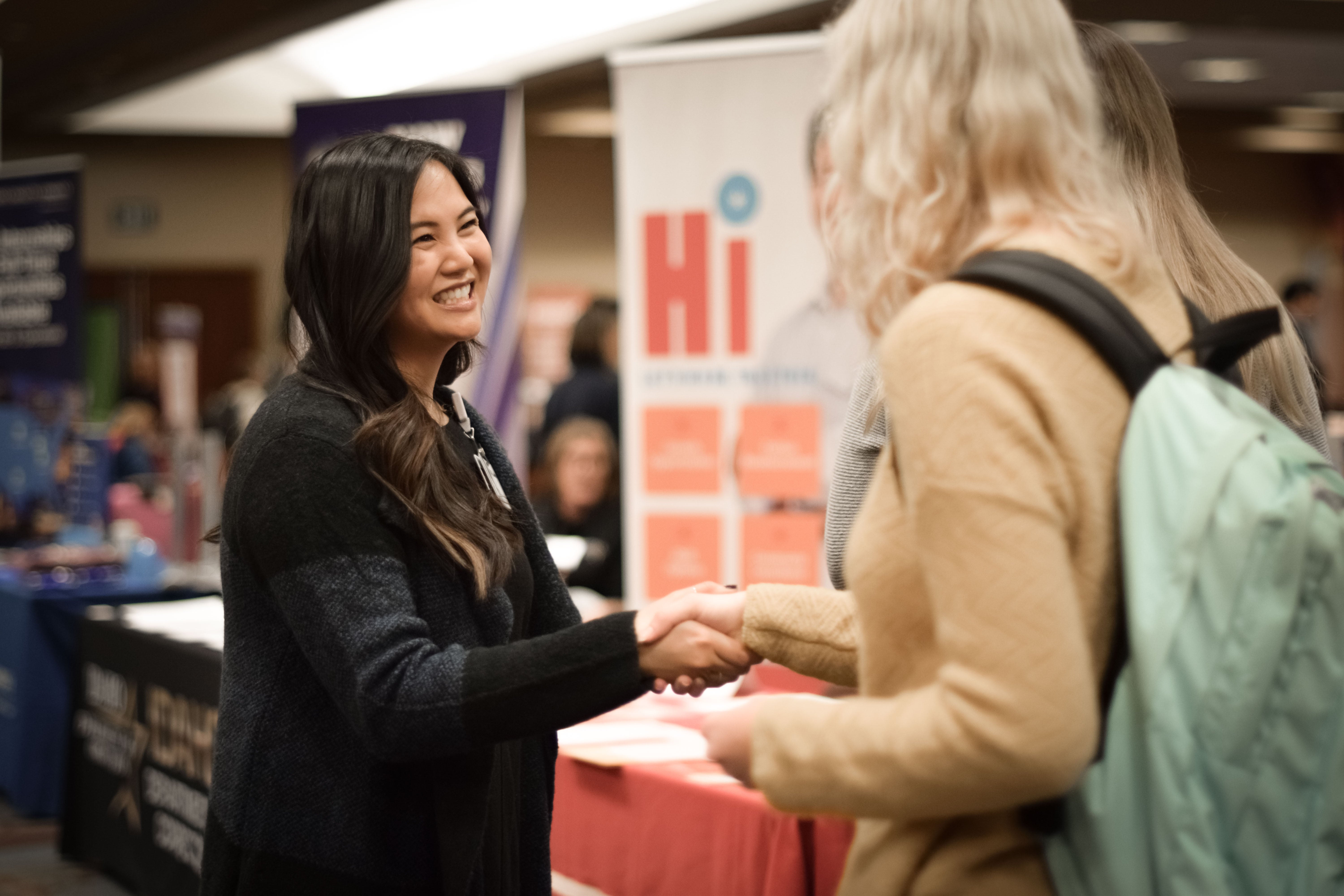 Student shaking hands with employer