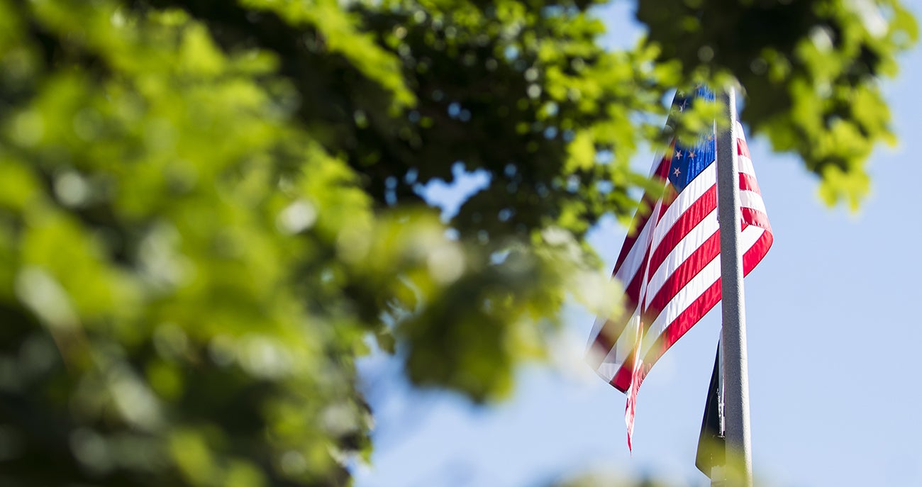 American flag behind tree on Boise State campus