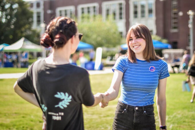 Student shaking hands with an employer at the part-time job fair