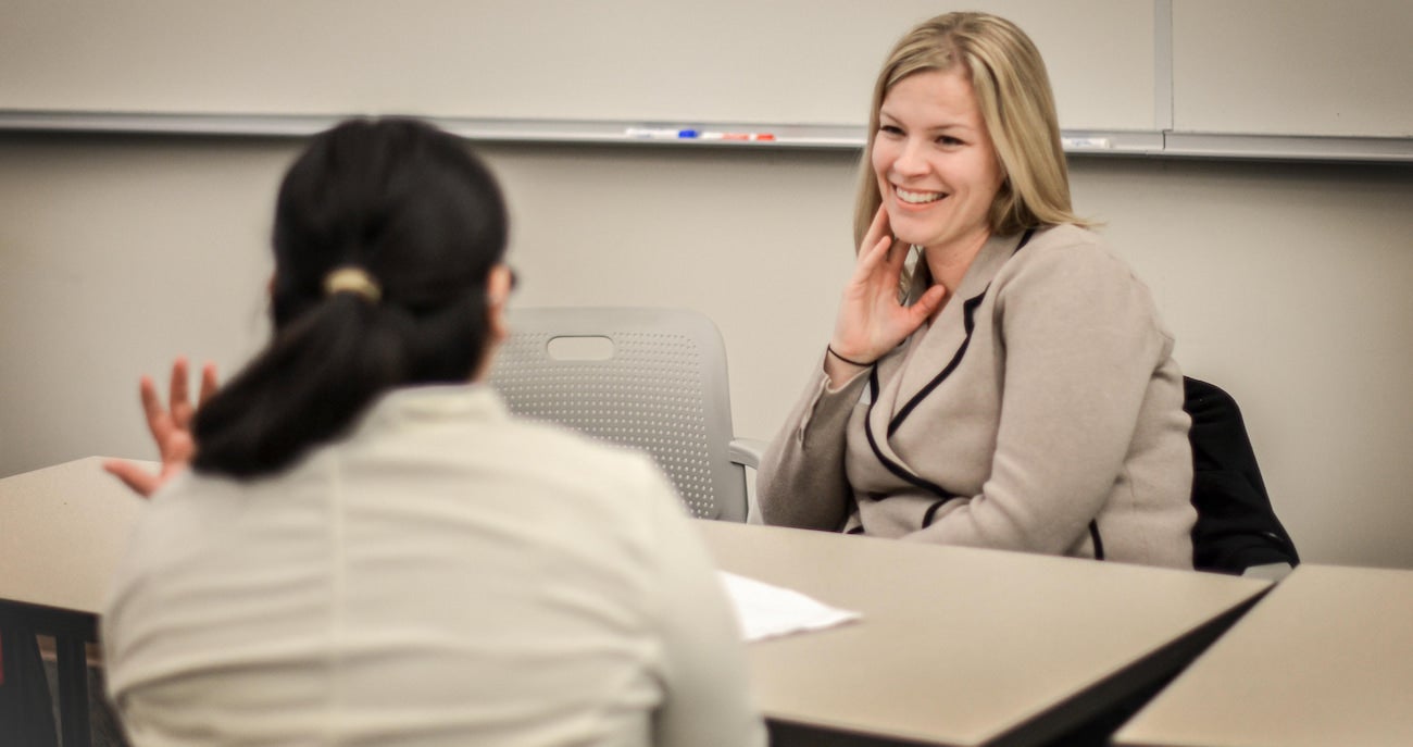 Employer smiling at a student from across a table