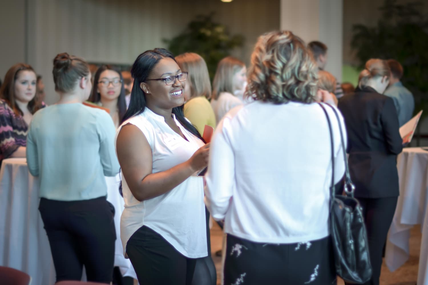 Student talking with an employer at a networking event