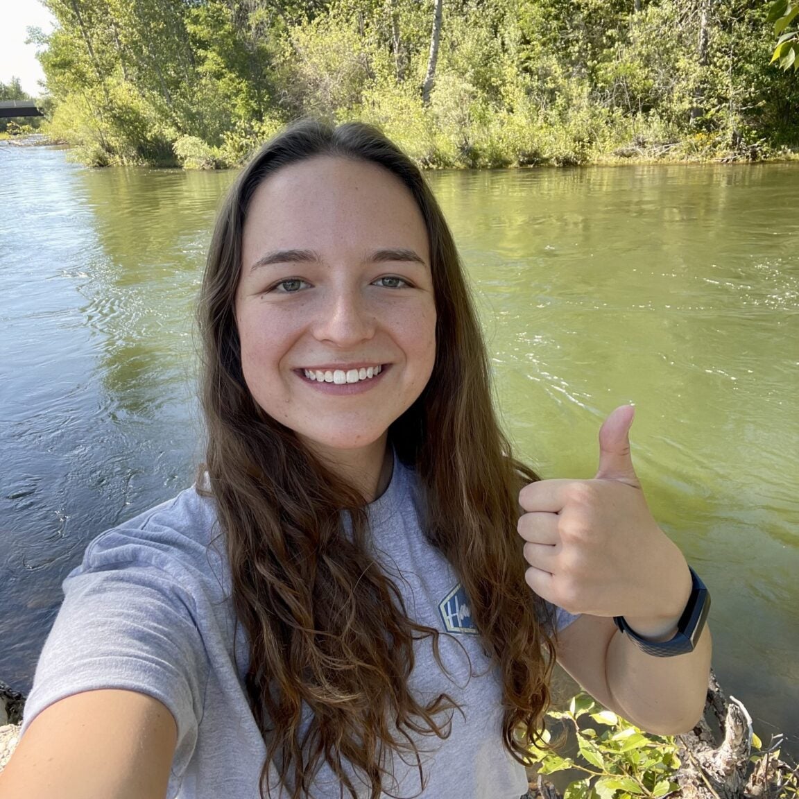 Photo of Kylie Johnson standing in front of the Boise River
