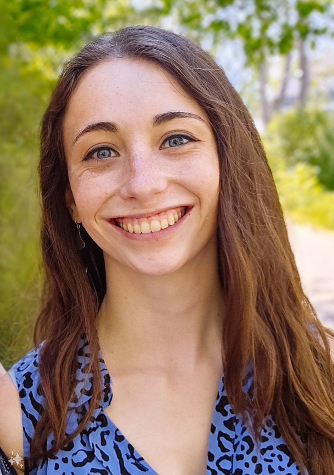 Photo of Audrey Thompson standing outside with trees behind her