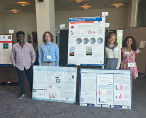 Photo of 4 Project SEED students standing around 3 research posters