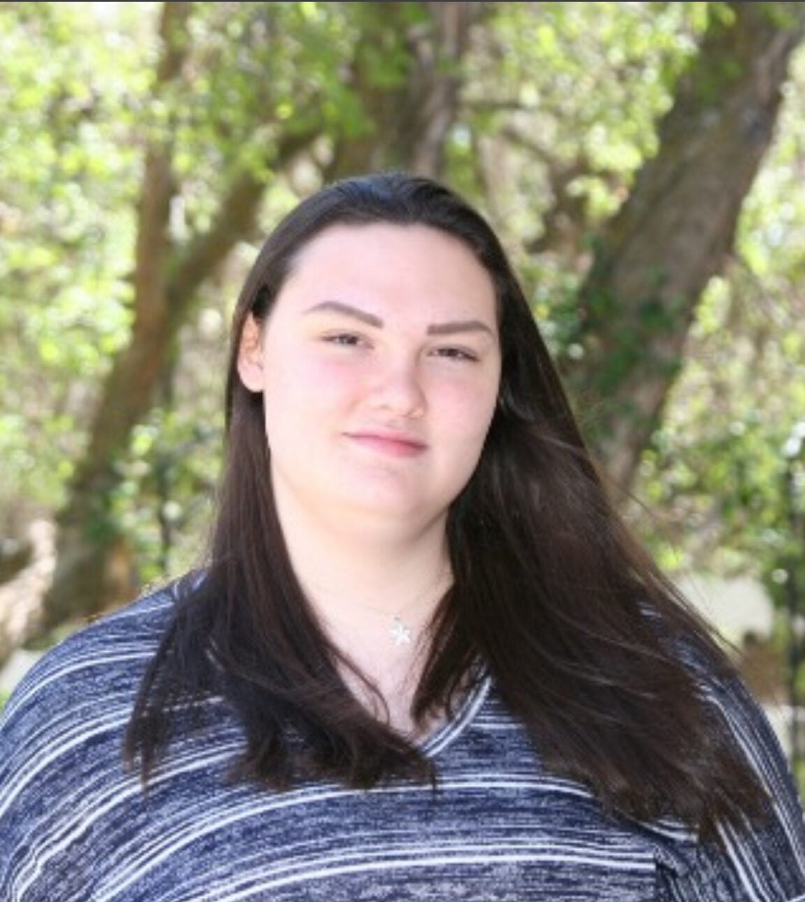 Photo of Christina Fischer standing outside in front of a tree