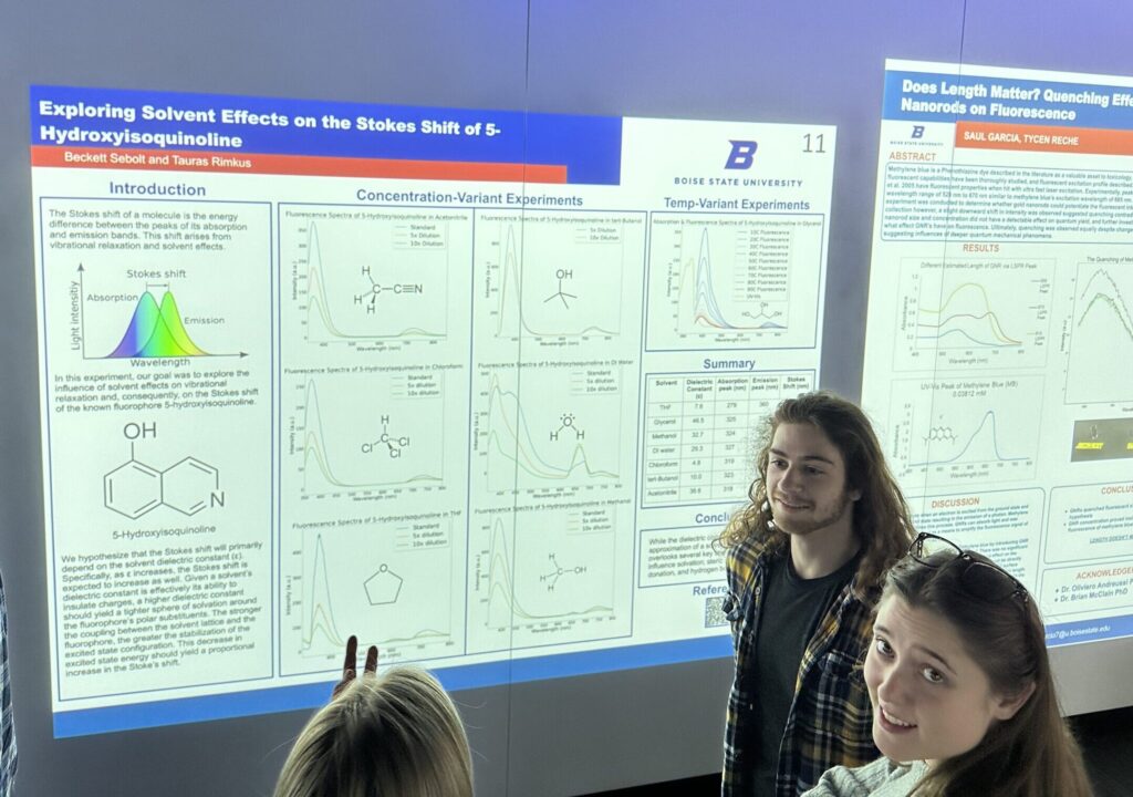 Photo of Tauras Rimkus and another student in front of a PChem poster