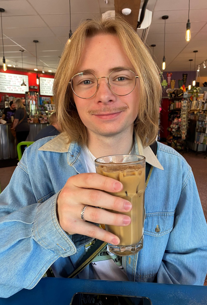 Matthew holding a drink in his hand