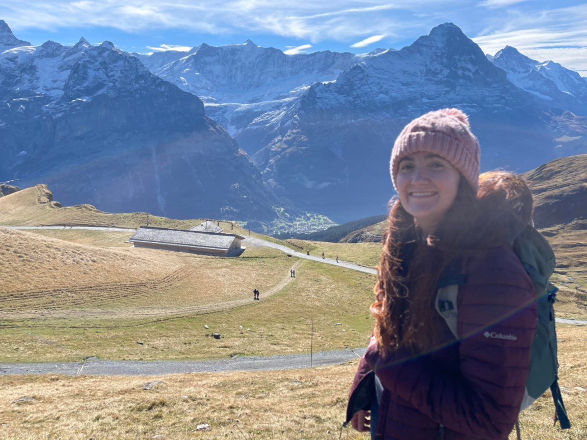 Photo of Rylli Burton standing outside with mountains in the background