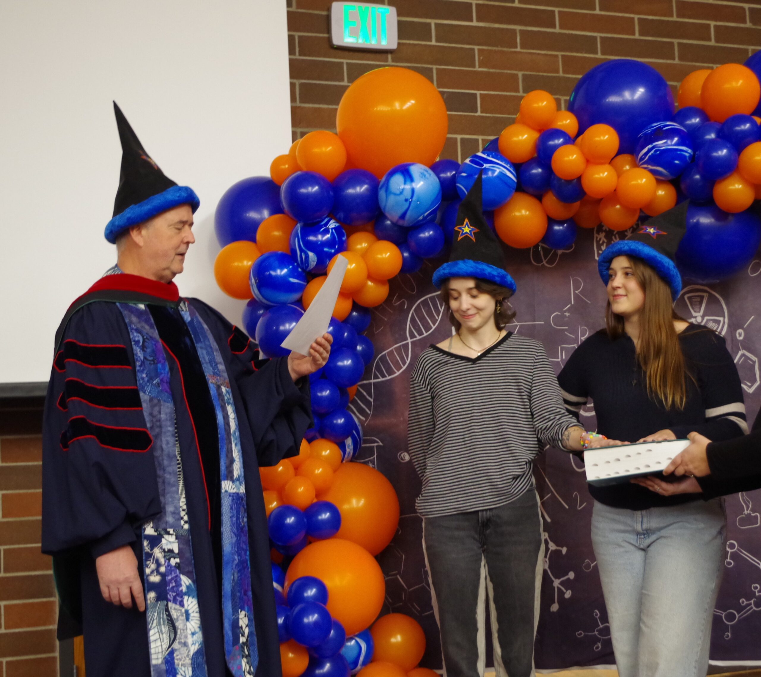 Photo of Kelso Hinrichs and Molly Gage taking the Wizard Oath, delivered by Ken Cornell