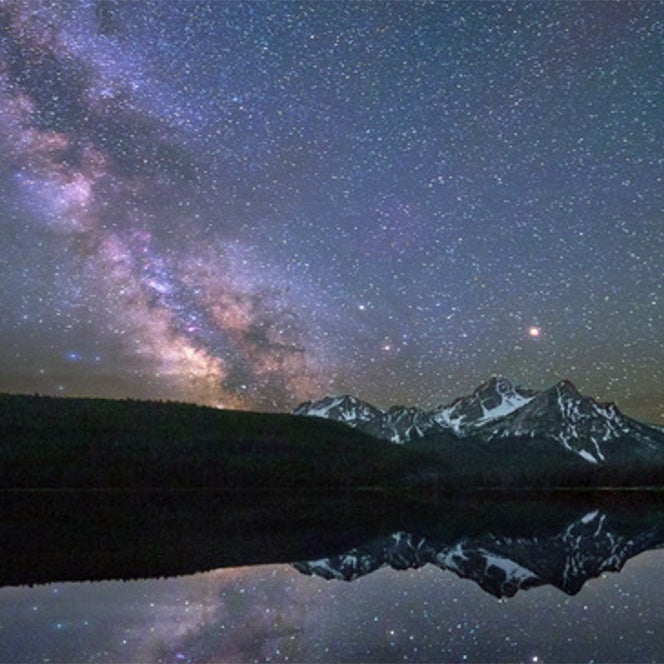 Photo of the Milky Way above Redfish Lake and the mountains in central Idaho