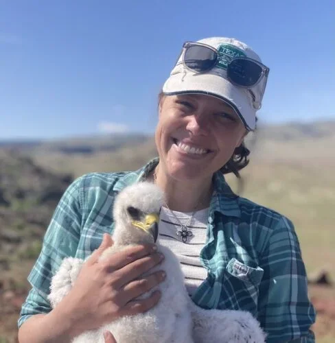 Photo of Stephanie Galla holding a Columbian Sharp-tailed grouse