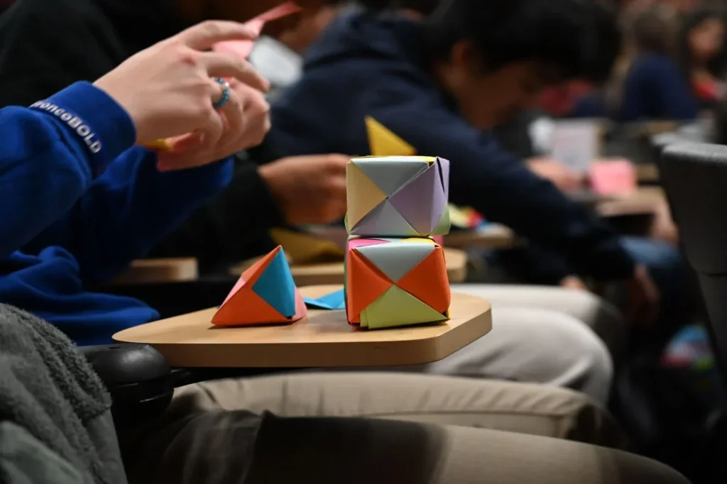 Origami shapes sitting on a desk in front of a student