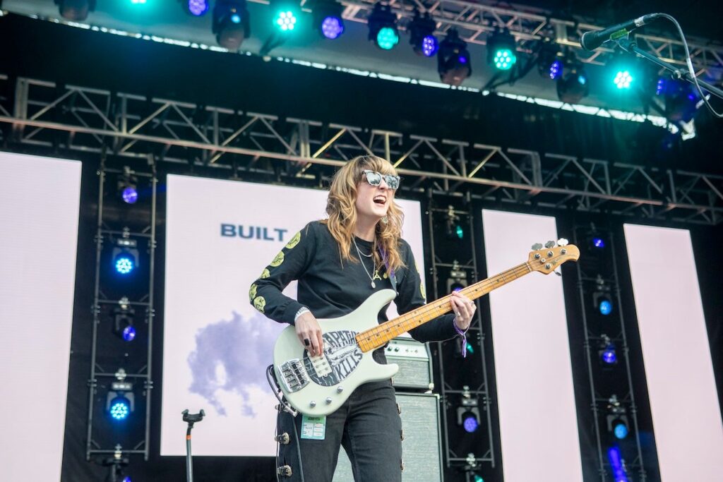 Melanie Radford playing bass guitar on stage