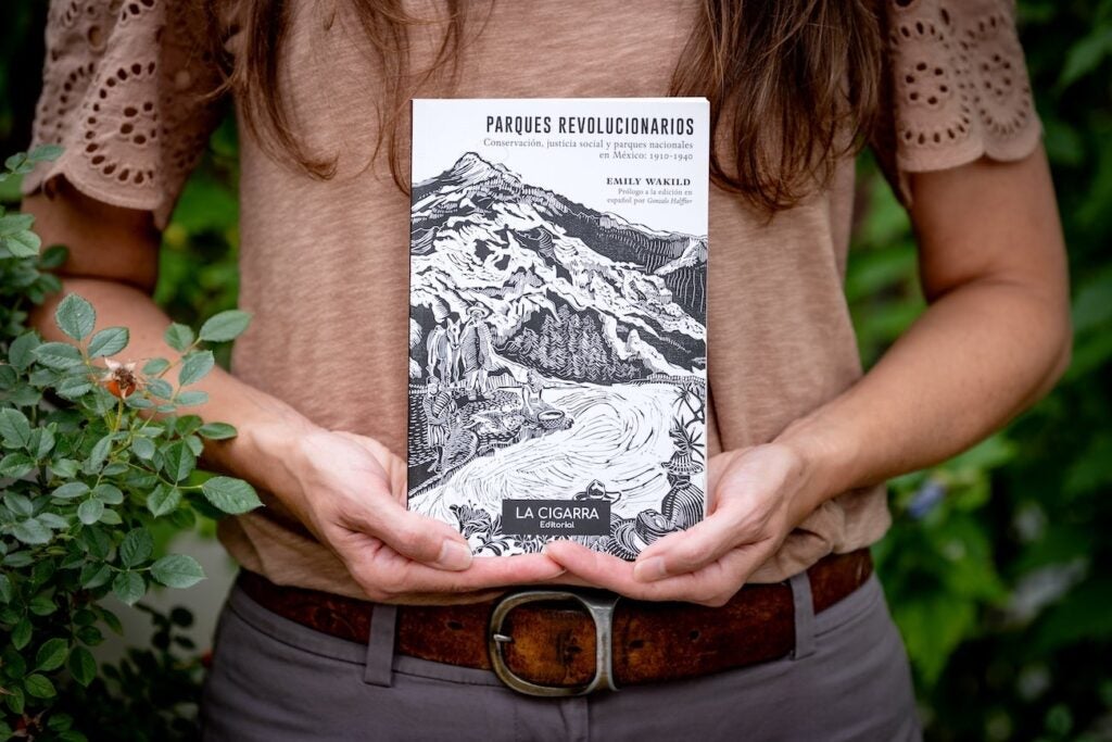 Emily Waklid holding her book