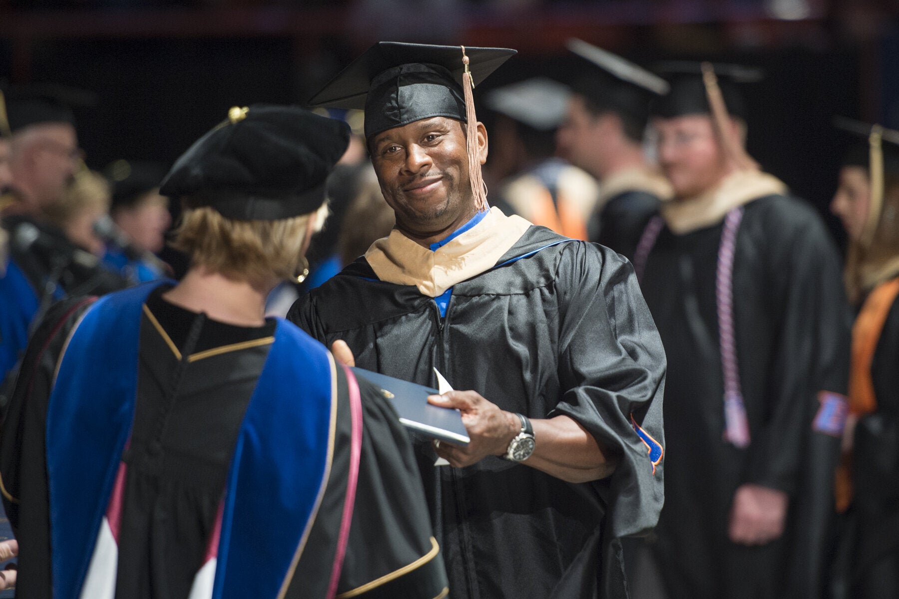 MBA student receiving diploma at commencement