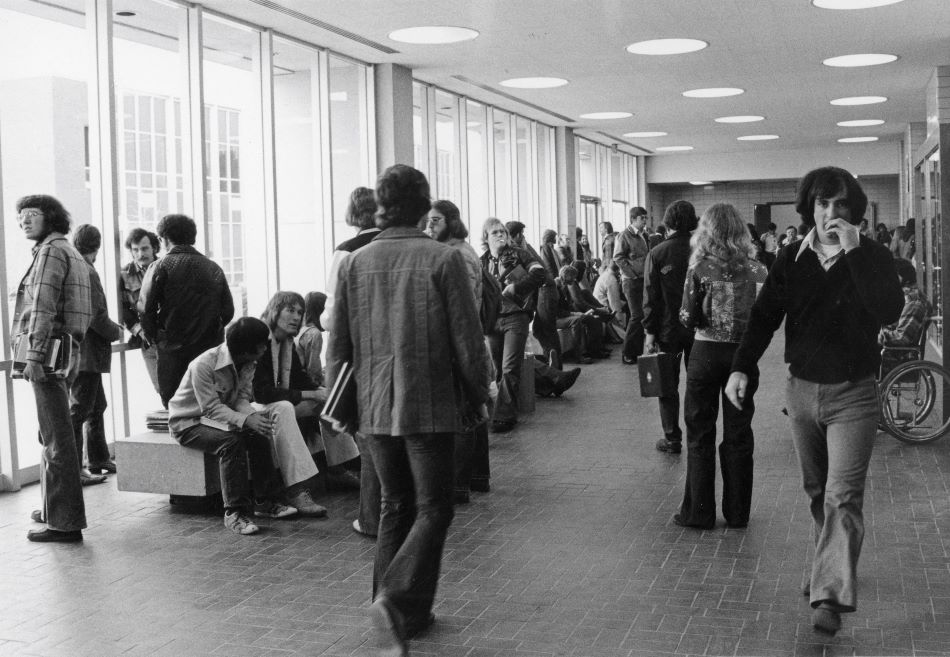 The lobby of the old Business Building (now Riverfront Hall) full of students - March 1975
