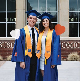 drew and kaitlyn in their graduation caps and gowns in the plaza at the Micron Business and Economics Building