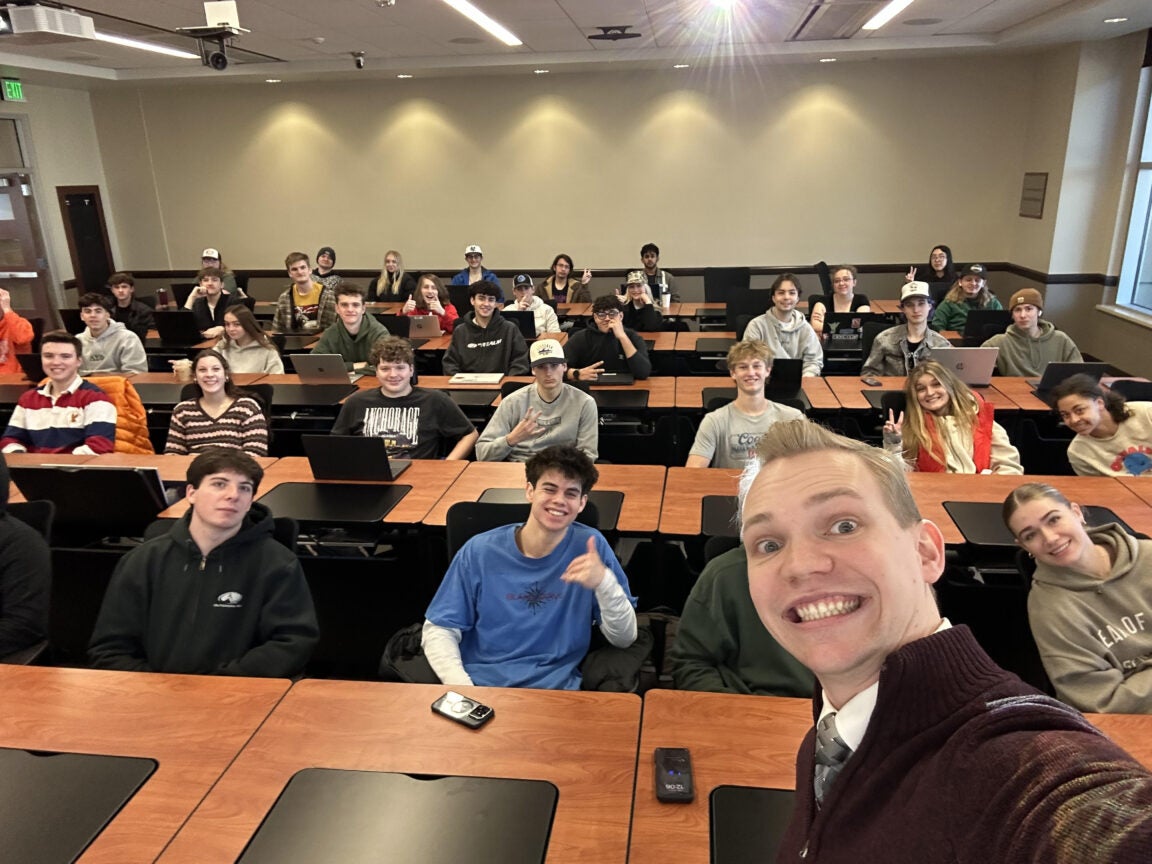 graduate assistant taking a selfie with an Information technology class