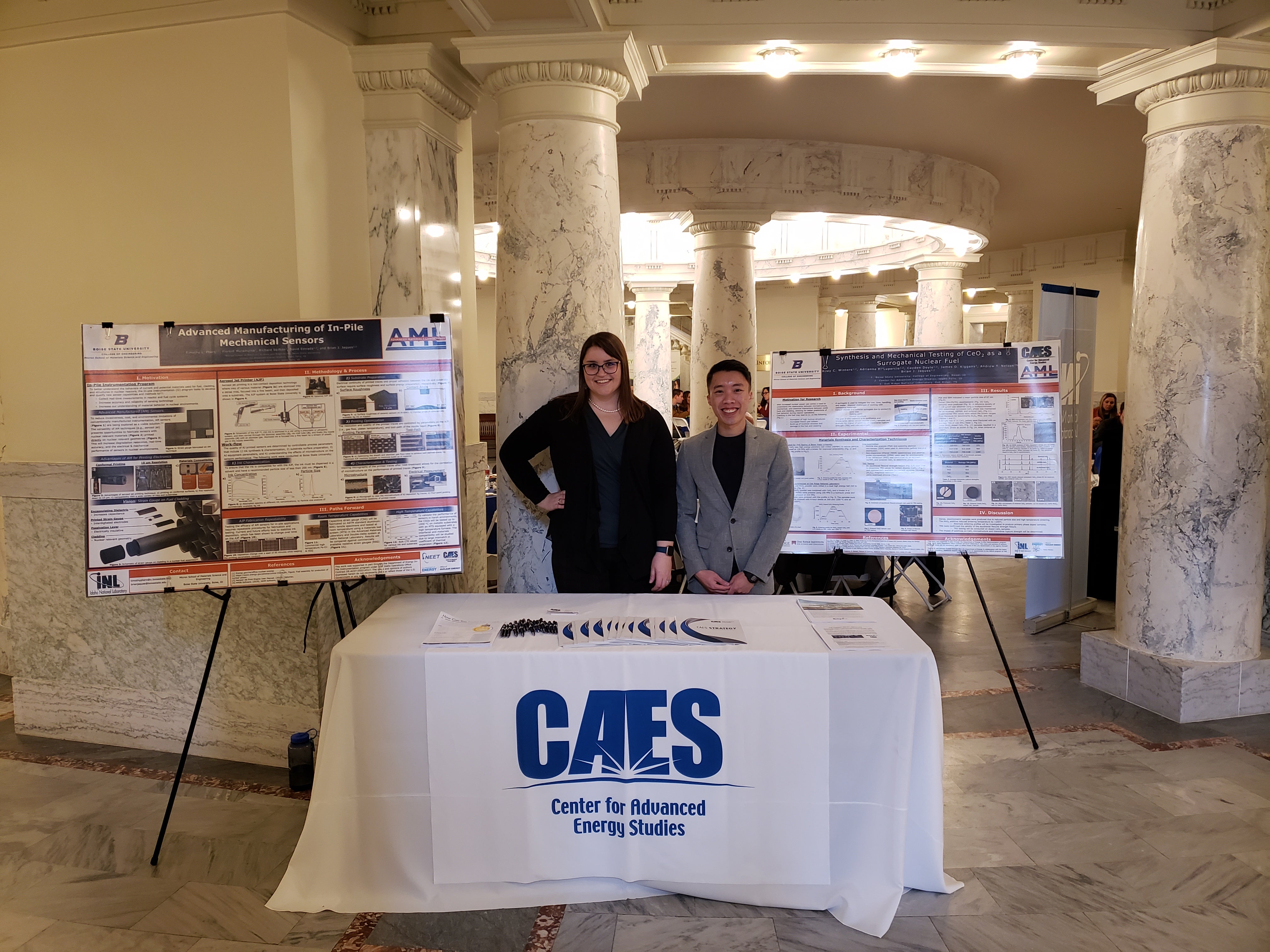 Riley Winters and another student with research posters