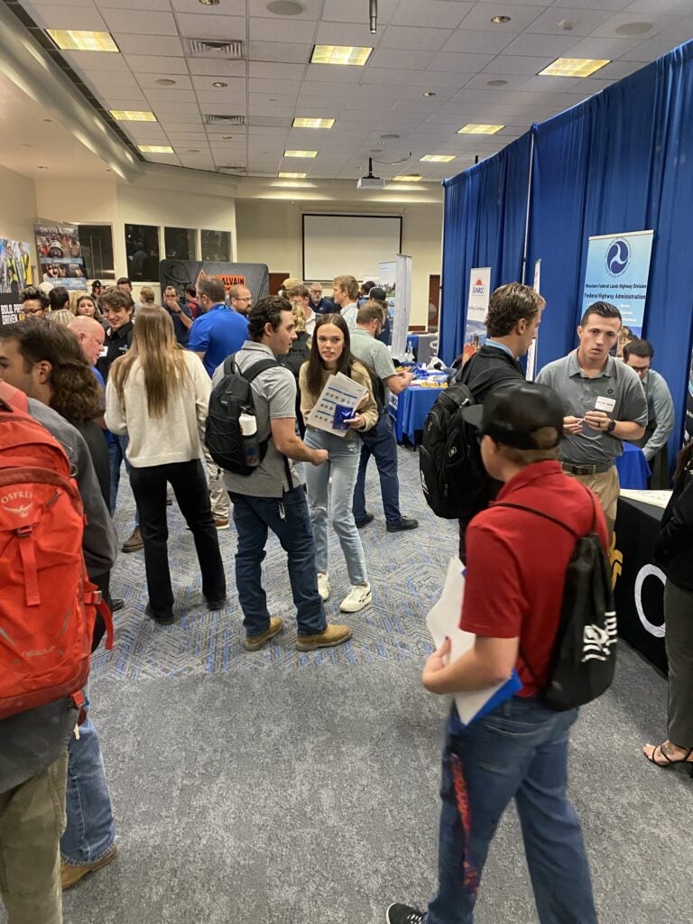 people standing in a room at a career fair