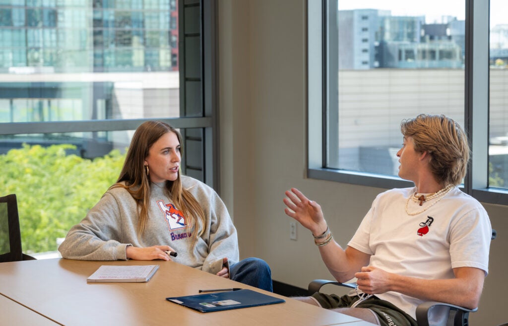 Two students discussing computer science.