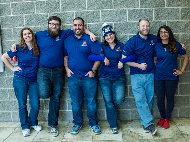 Six Boise State students posing with interlocked arms