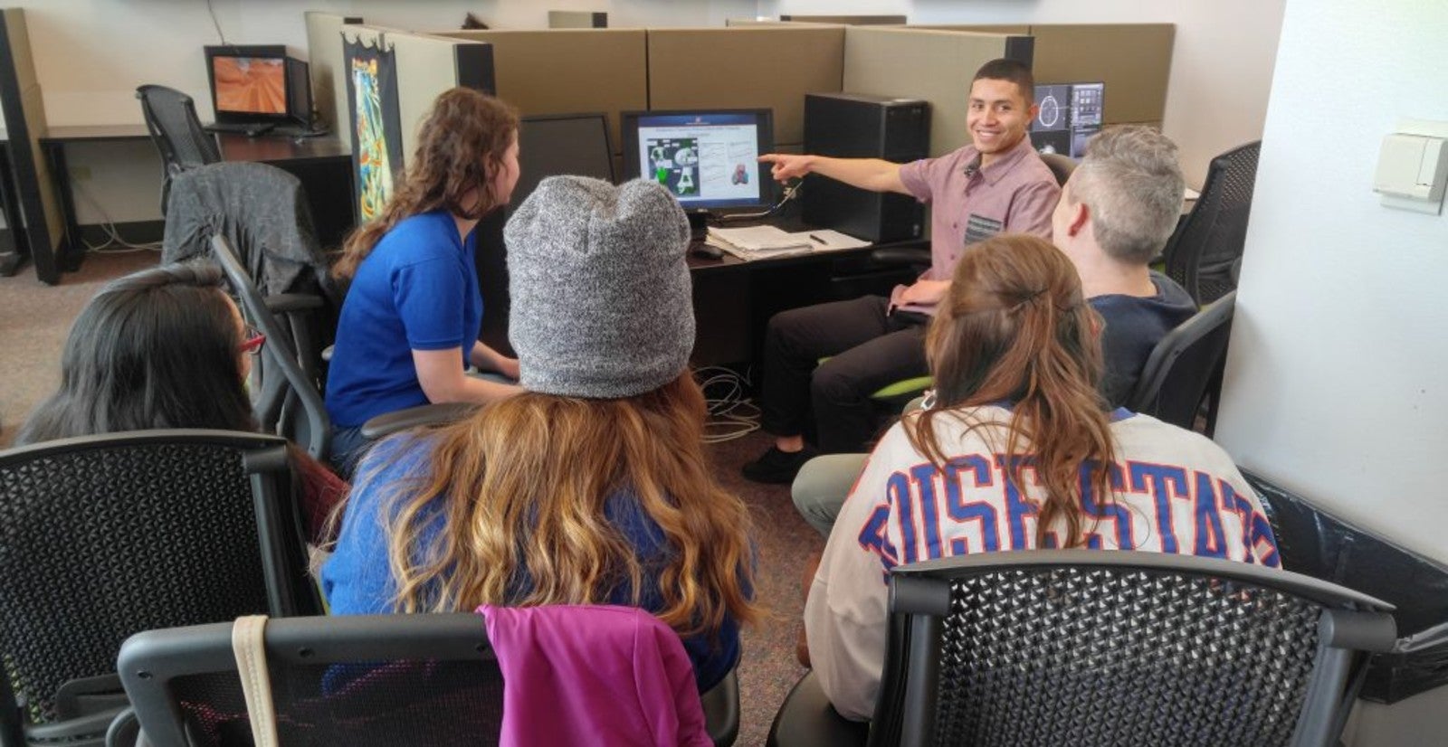 students gathered around a computer looking at a simulation