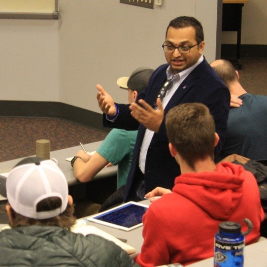 an instructor talking to a student in class