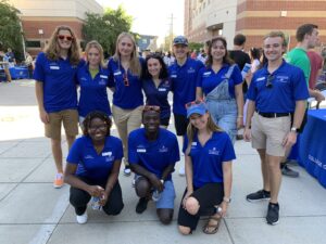 a group of students posing for a picture all wearing matching shirts