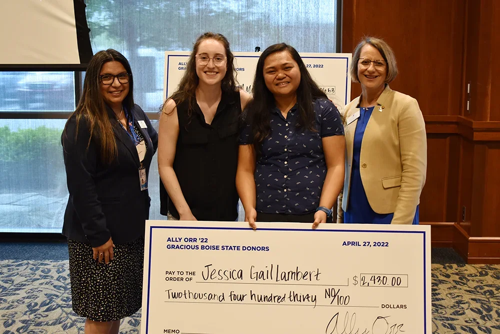 Scholarship Recipients holding a large check