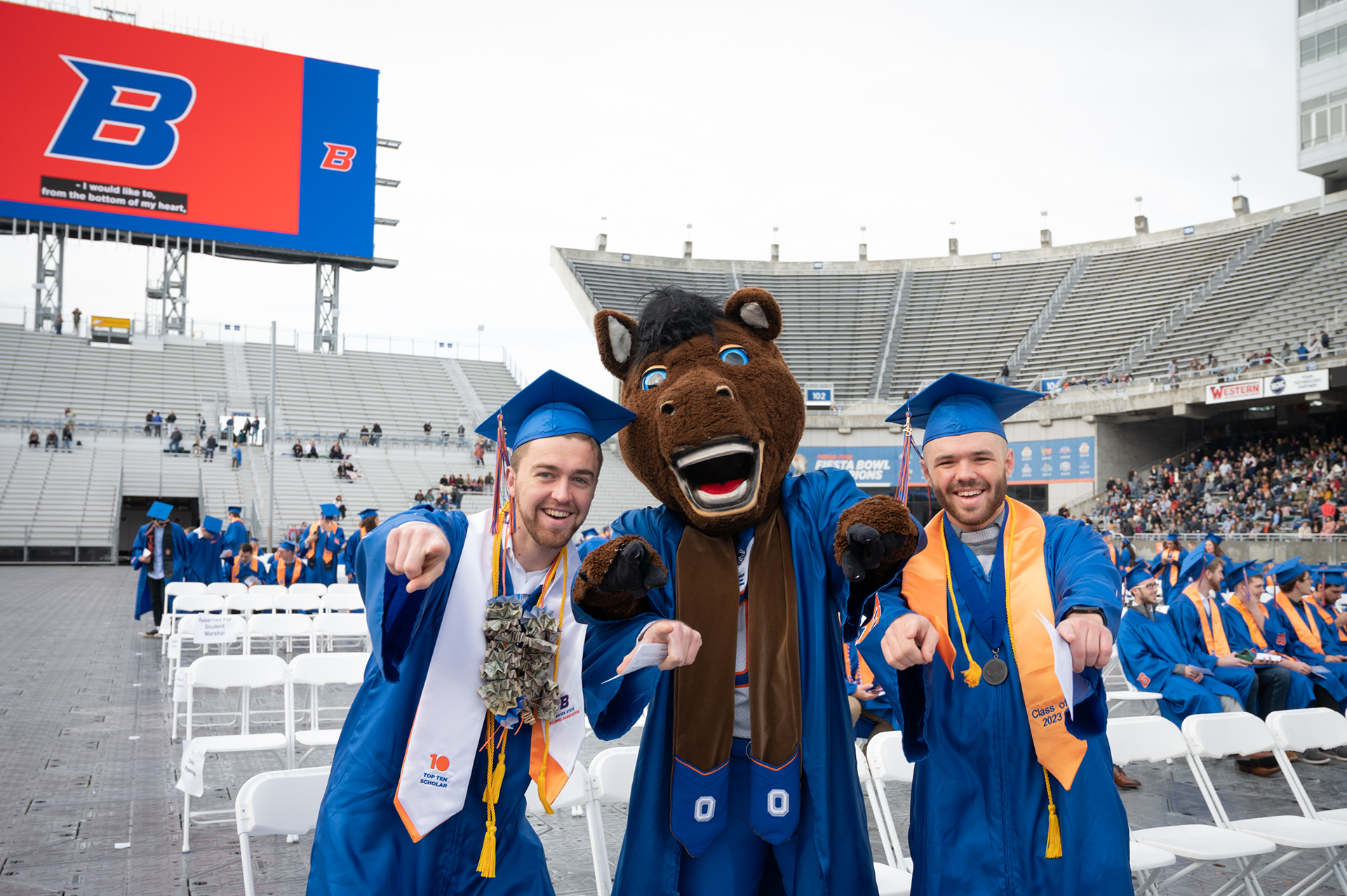 College of Engineering grads pose with Buster Bronco at the Spring 2023 commencement.