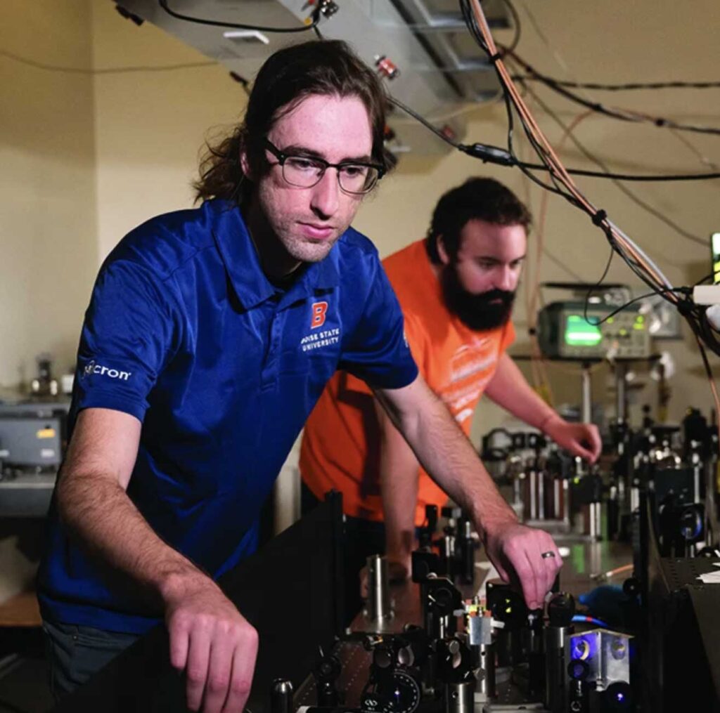 2 men working with equipment in a lab