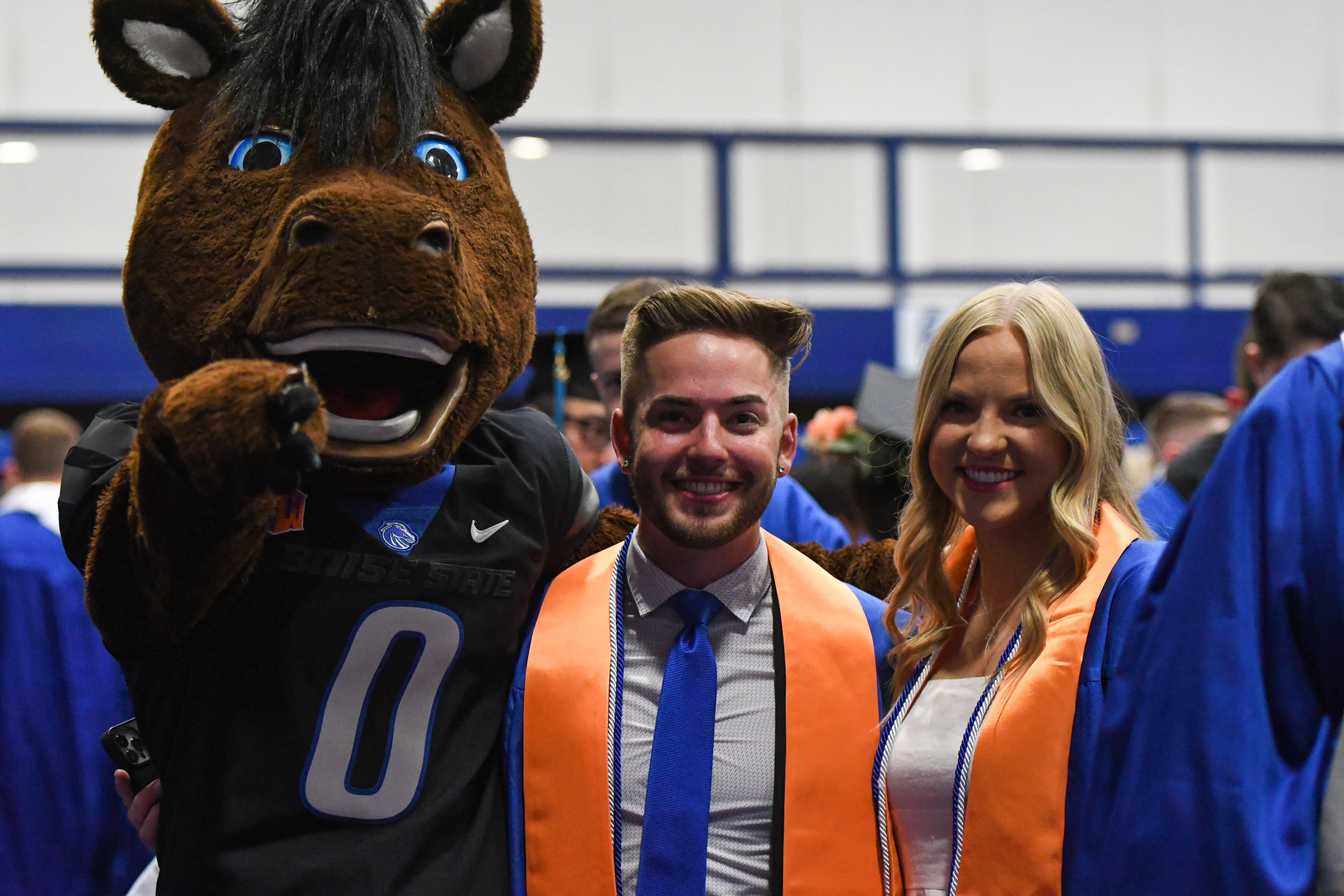 Graduates with Buster Bronco