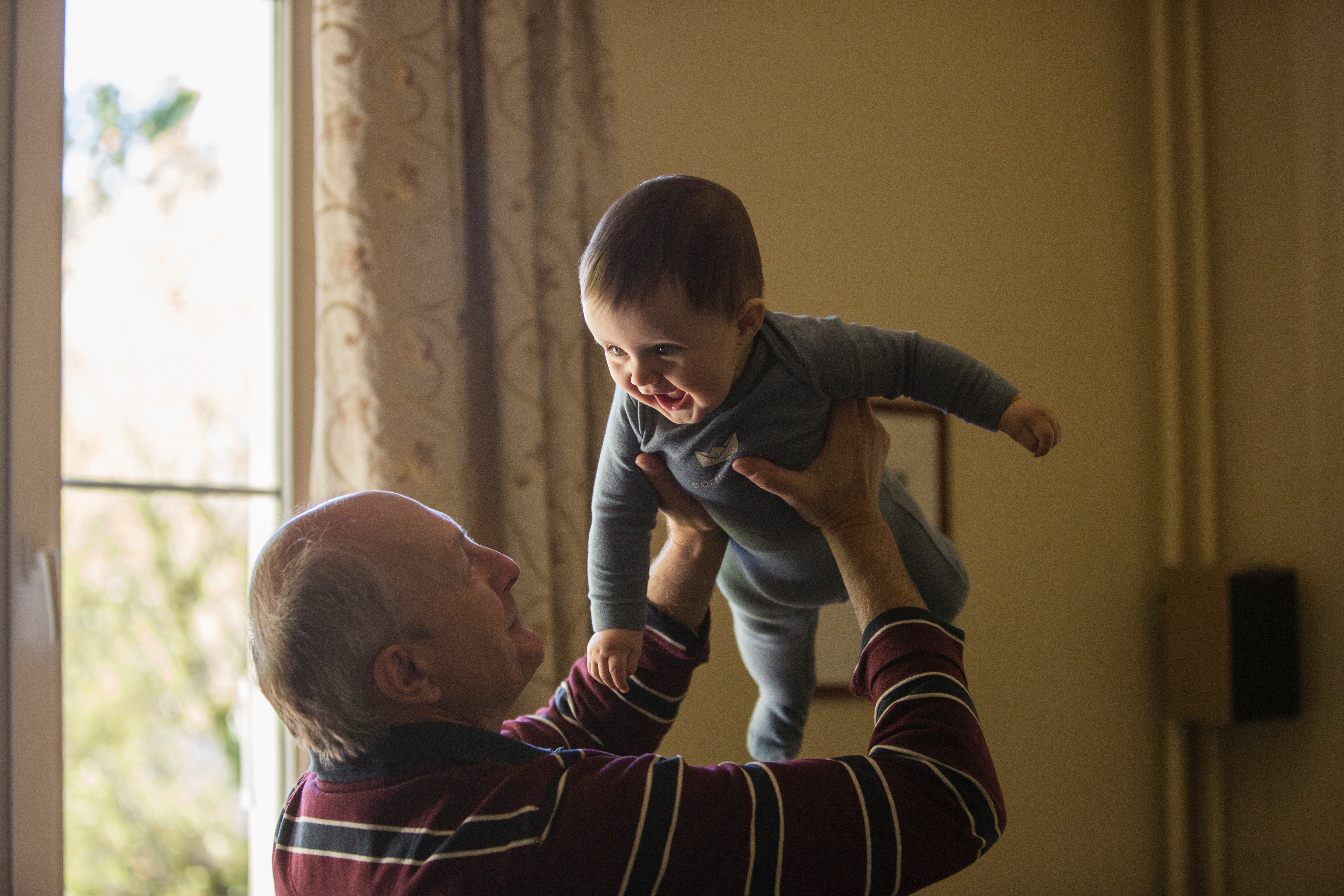 Grandparent holding a smiling baby