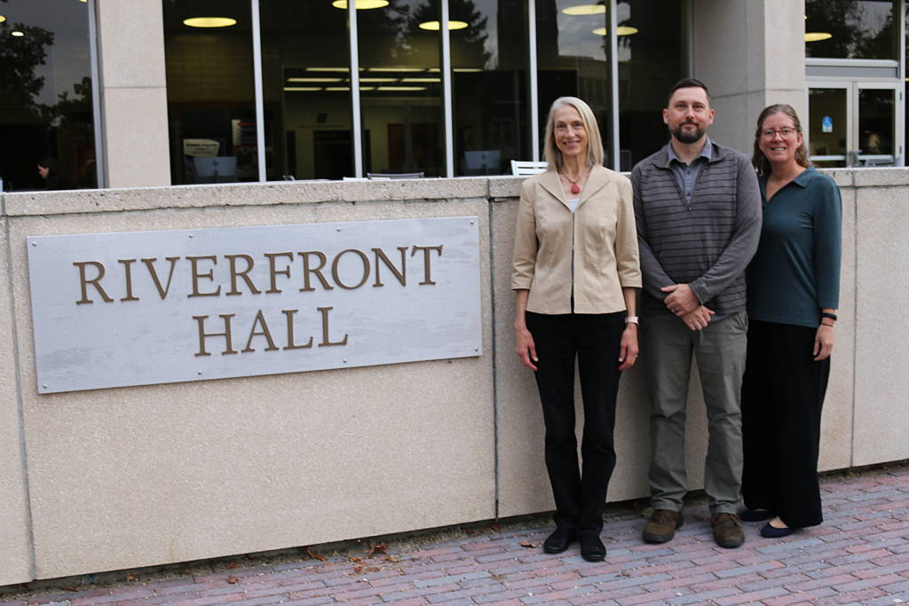 The Service-Learning team stands in front of Riverfront Hall. From left to right: Kara Brascia, Casey McGee, and Erin Rausch.