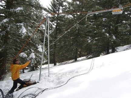 Heilig working on equipment in snow