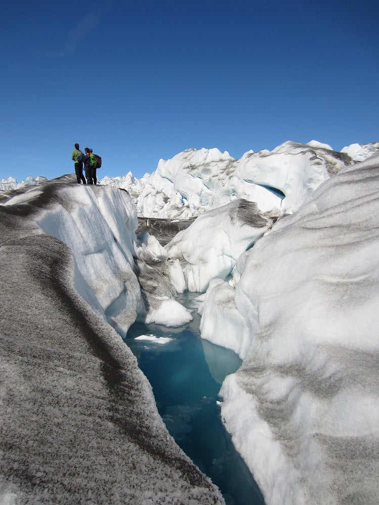 People standing on the edge of a glacier