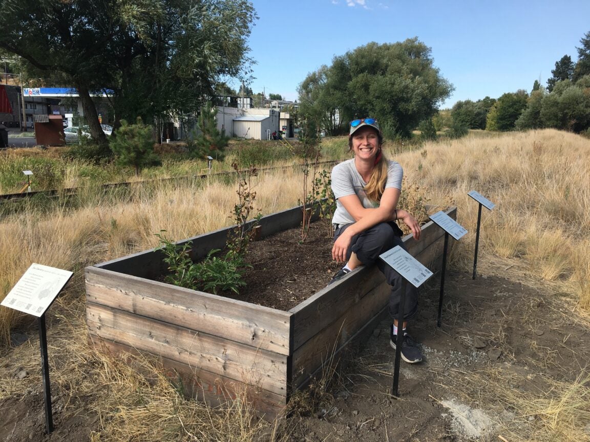 Photo of Kayla Wakulich sitting on a farm bed